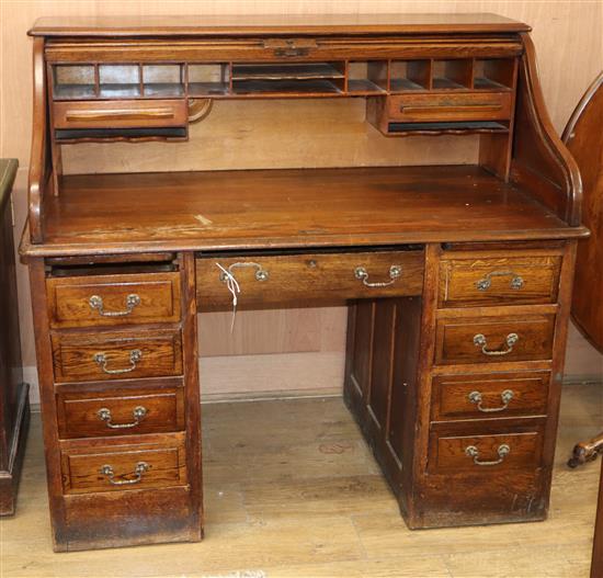 A 1920s oak roll top desk with S shape tambour W.126cm